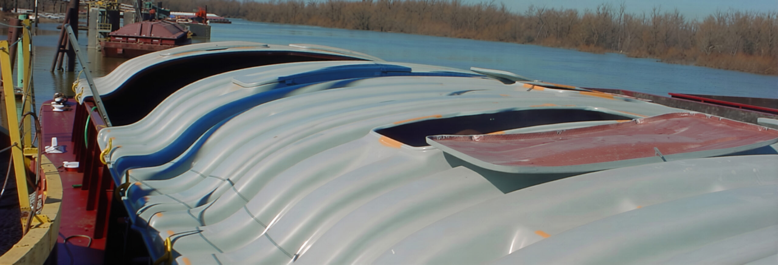 NABRICO fiberglass covers installed on a hopper barge